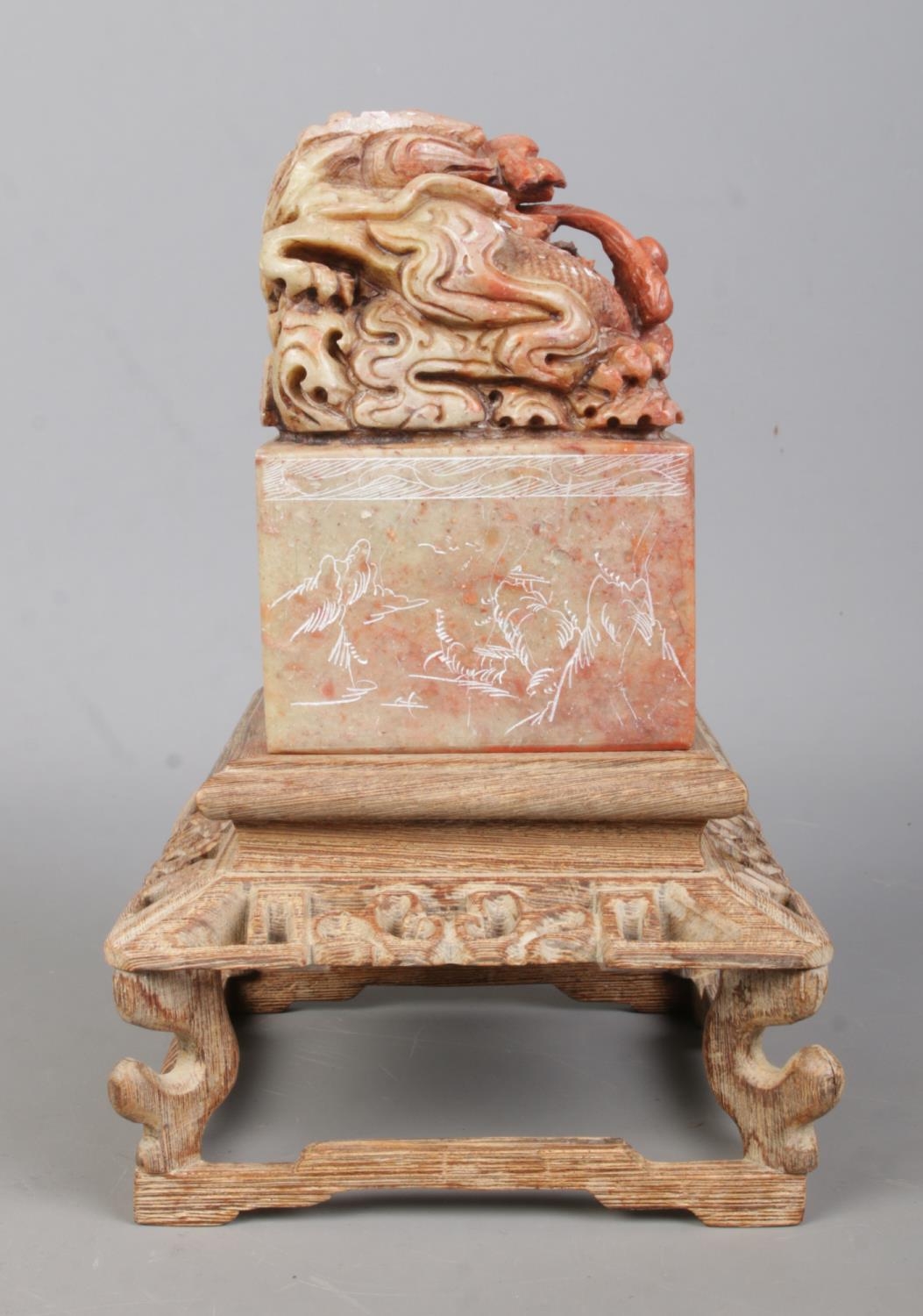 A Chinese carved soapstone seal raised on carved wooden stand. The seal surmounted with a Qilin - Image 3 of 7