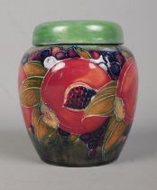 A Moorcroft pottery pot pouri jar decorated in the Pomegranate design. Signed to base. Height