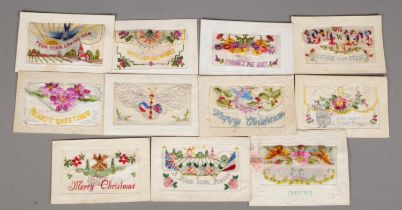 Eleven World War One era silk embroided postcards with secret pocket.