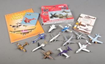 A small collection of diecast aircraft including matchbox examples and related books and Airfix set.