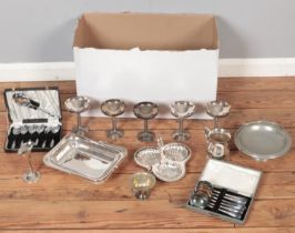 A box of metalwares. Includes tankards, trays, cased flatwares, drinking vessels, etc.