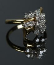 An 18ct gold and diamond trumpet cluster ring. Size R 1/2. 7.03g.