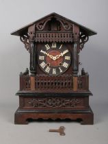 A late 19th/early 20th century Black Forest cuckoo mantel clock. Housing twin train movement and