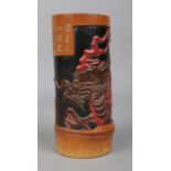 A Japanese bamboo brush pot. Having carved decoration, depicting a dragon and calligraphy. Height