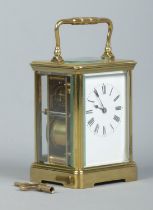 An early 20th century brass and glass repeater carriage clock. Having swing handle, Roman numeral