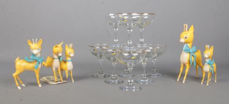 A collection of Babycham to include nine drinking glasses and five fawn figures of varying sizes and