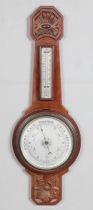 A carved mahogany Aneroid barometer. 64cm