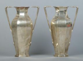 A pair of Edwardian silver twin handled vases of octagonal baluster form. Assayed London 1903 by