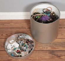 A hat box containing a large amount of assorted costume jewellery to include simulated pearls,