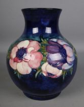 A Moorcroft Pottery vase decorated in the anemone pattern, signed to the base. Hx19.5cm