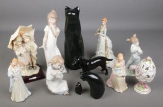 A collection of figurines including Nao figures of yawning girl and girl with doll, The Franklin