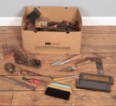 A box of tools. Includes Stanley plane, trowel, screwdrivers, etc.