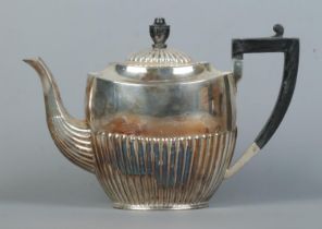 An Edward VIII silver tea pot with ebonsided handle and finial. Assayed Sheffield 1936 by Atkin