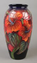 A Moorcroft pottery vase decorated in the Hibiscus Flambe pattern by Kerry Goodwin. Date cypher