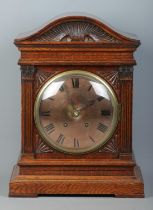 A carved oak cased Winterhalder & Hofmeier bracket clock. Having Roman numeral markers and chiming