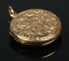 An early 20th century locket with chased decoration. Stamped 15ct to back. 4.27g. Some light surface