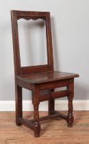 A small late 18th/early 19th century oak chair of jointed construction. Height of back 88cm. Signs