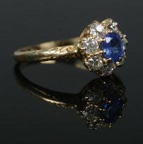 A Victorian 18ct gold sapphire and diamond halo cluster ring. Central stone approximately 0.5ct.