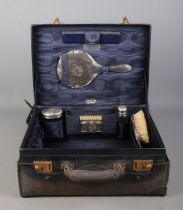 A Finnigans of Manchester vanity case with assembled silver mounted accoutrements all bearing the