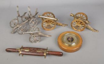 A quantity assorted collectables to include several brass desk canons, Guchard barometer and