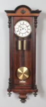 A 19th century walnut Vienna twin weight wall clock. Chiming on a coiled gong.