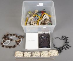 A tin of costume jewellery. Includes boxed Jon Richard jewellery suite, brooches, beads,