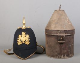 A British Royal Artillery helmet with blue cloth and spike. Inside of helmet marked for Guthrie &
