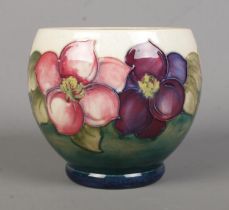 A Moorcroft pottery vase decorated in the Clematis design. Signed to base. Height 11.5cm.