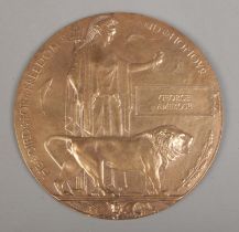 A World War One bronze memorial plaque/death penny awarded to George Ambrose.