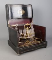 A French 19th century ebonised liquor cabinet with brass and walnut inlaid decoration. Contents of