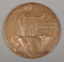 A World War One bronze memorial plaque/death penny awarded to William Wilks.