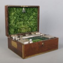 A William IV brass bound rosewood vanity box with fitted silver and glass jars. The box and jars all