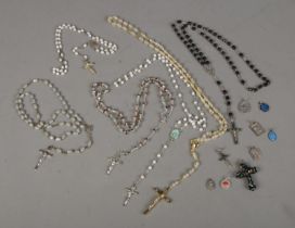 A small quantity of rosary bead necklaces with crosses and other religious themed pendants.