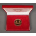 1986 Bahrain Saudi Causeway gold coin in original display case and sleeve. 31.18g.