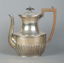 A Victorian silver hot water pot with wooden handle and turned finial. Assayed Sheffield 1888 by