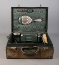 A Finnigans of Manchester leather vanity case with contents of assembled silver mounted