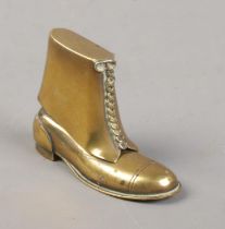 A brass novelty lighter in the form of a boot.