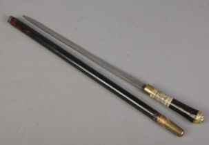 An ebonised short sword stick with carved bone collar and brass lion head pommel. Length of blade