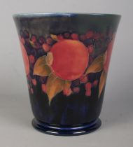 A Moorcroft pottery bell shaped vase decorated in the Pomegranate design. Signed to base. Height