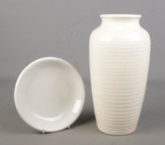A Moorcroft natural/white glazed ribbed vase along with a similar Moorcroft dish. The vase having