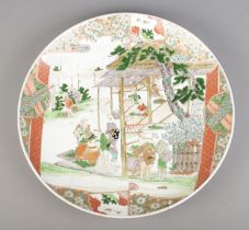 A very large Japanese charger hand painted with landscape scene and figure. Six character mark to