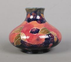 A Moorcroft pottery vase of squat form decorated in the Pomegranate design. Signed to base and
