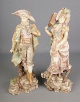 A pair or ceramic figures in the style of Royal Dux. Hx46cm approx. Signs of repair to the male