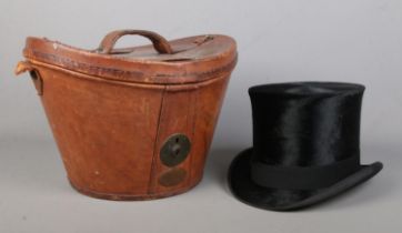 A Victorian Tress & Co silk top hat in fitted leather box. Front to back 20cm, side to side 16cm.