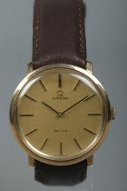 A gents 9ct gold Omega De Ville manual wristwatch. Having champagne dial and baton markers.