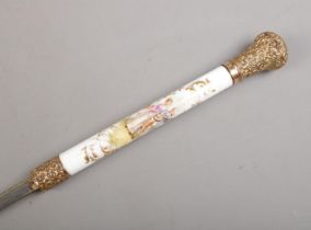 A bamboo cased sword stick. Having porcelain grip, hand painted with Sevres style scenes and gilt