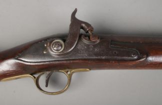 A 19th century rifle with walnut stock. Percussion conversion from flint lock. The lock plate