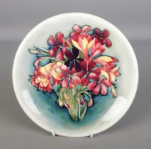 A Moorcroft Pottery "Spring Flowers" plate. 26.5cm