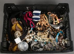 A box of costume jewellery. Includes beads, bangles, necklaces, etc.