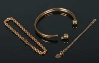 Three pieces of 9ct gold jewellery. Includes rope twist bracelet, trace bracelet with heart shaped